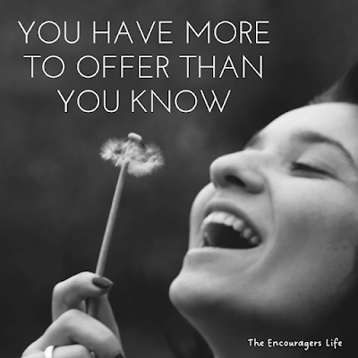 Black and white photo of woman laughing as she blows on a dandelion.  Text reads, "You have more to offer than you know.  The Encouragers Life.".