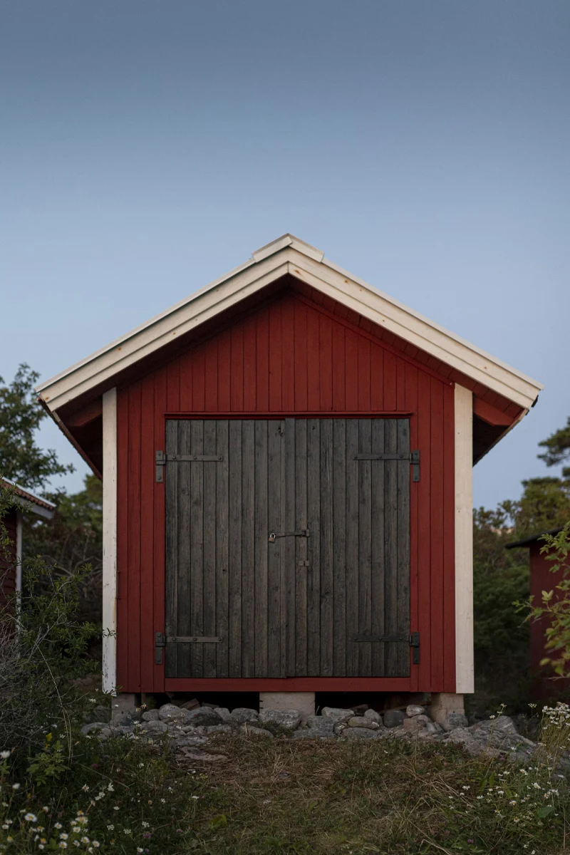 a symmetrical picture of a red shed