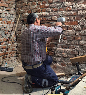 Bekir fits a double socket on the wall