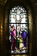 . and a small stained glass window depicting the crucifixion behind it.
