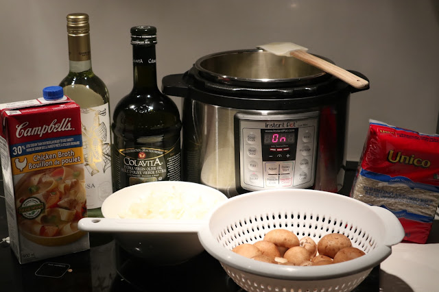 All the ingredients necessary to make pressure cooker risotto (chicken broth, Pinot Grigio White Wine, Olive Oil, Mushrooms, Arborio Rice, Chopped Onions and Garlic)