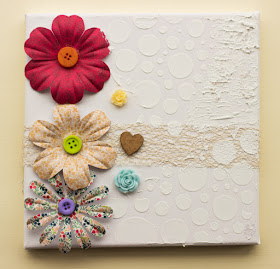 canvas with floral embellishments and tecture paste