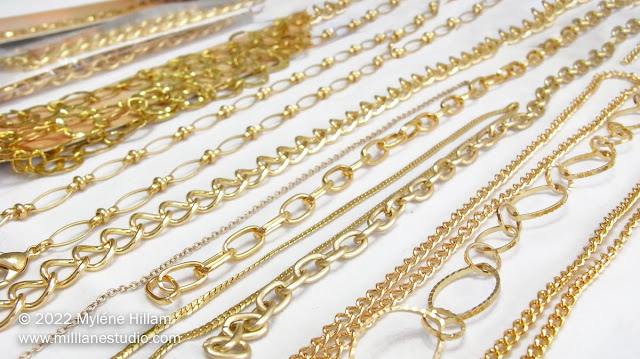 rows of fancy link gold chains on a white background