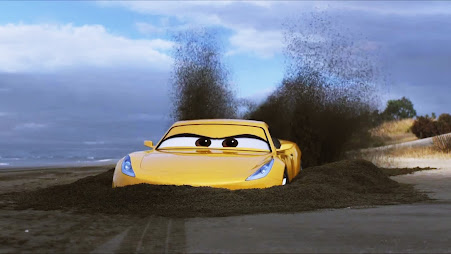 Cruz Ramirez, a yellow Sports Coupe, halfway buried in sand