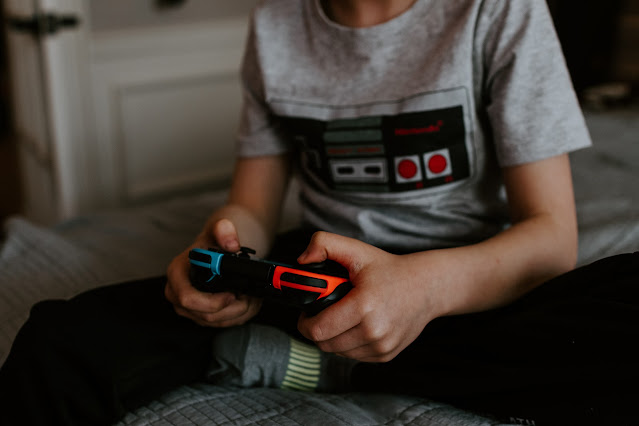 kid wearing an atari shirt playing educational video games