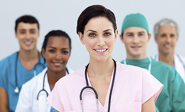 Female Doctor standing in Front of her team