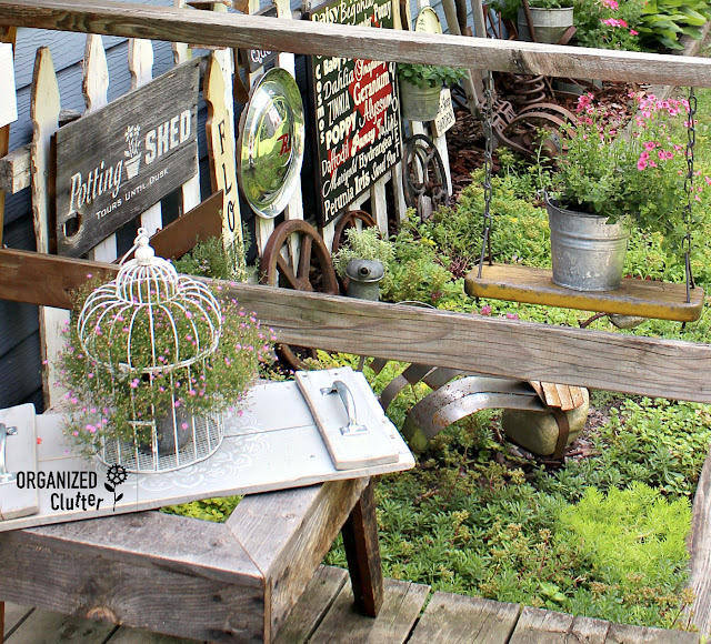 Photo of junk garden vignettes on the corner of the deck