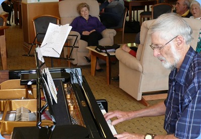 Errol Storey playing the grand piano. Photo courtesy of Dennis Lyons.