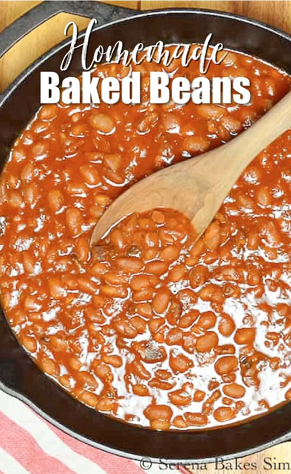 A down shot of Homemade Baked Beans in a cast iron pan with with text at the top Homemade Baked Beans.