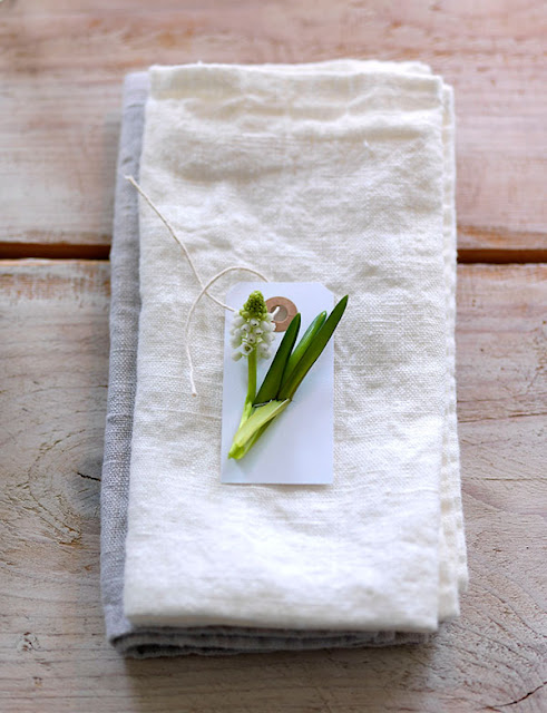Gorgeous spring bloom on linen napkin on farmhouse table