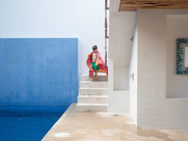 Niño bajando unas escaleras junto a una piscina