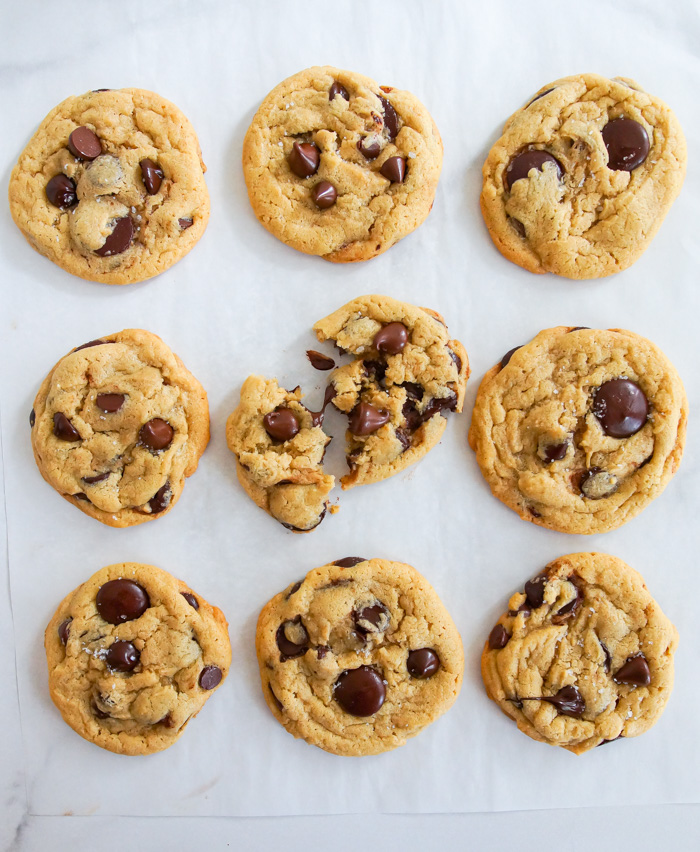 salted tahini chocolate chip cookies on white parchment paper