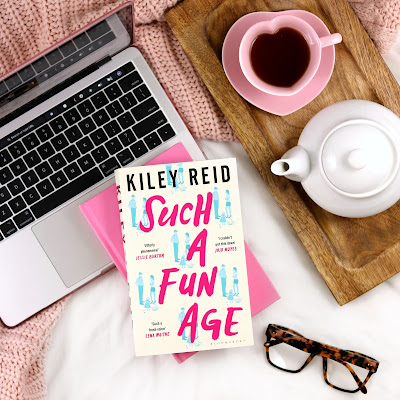 Kiley Reid Such a Fun Age Book Review - Book on Top of Laptop with Cup of Tea and Reading Glasses