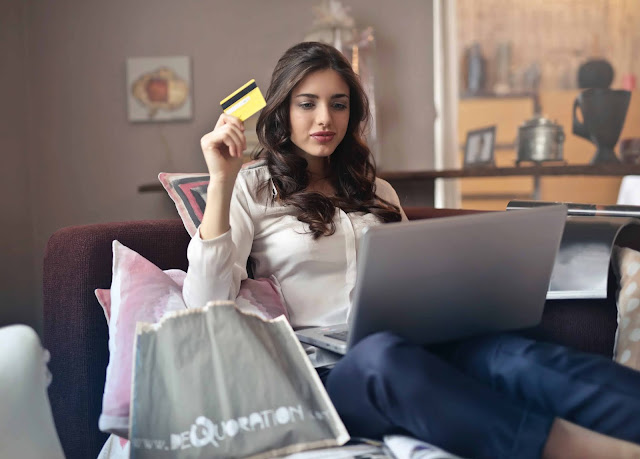 Beauty woman holding credit card and laptop