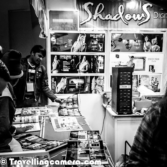 6th Jan 2013 was last day of Consumer Electronic Imaging Fair, which is popularly known as annual Photo Fair. It's a platform for Photography related businesses to showcase their products, technologies and innovations to Photographer community. This time Nikon and Canon were missing from this fair which was quite odd and overall excitement was also lesser. Let's check out this Photo Journey to know what else was there at Photo FairThis was the best part of Delhi Photo Fair 2013 ! Almost every branding poster had some very good messages writen, with significant real estate allocation to it. Messages like 'RESPECT WOMEN' and 'SAVE GIRL' etc. Big Thanks for Consumer Electronic Imaging Fair Organizers !!!In absence of Nikon and Canon, Sony was one of the biggest stall owner in Photo Fair. All registration counters had SONY branding and there was elaborated setup at Sony corner. There was a dedicated platform with some models and their mirriless cameras are feathered to screens around it. It was great to see a huge corner occupied by Xerox, the company which has contributed a lot to evolution of printing industry. In between, Xerox was lost somewhere and now seemed like a well equipment competitor for companies in printing domain. How can I miss the company which gifted a camera to me, few months back. Fujifilm is well equipped with different ranges of DLSRs & Mirroless cameras for serious photographers. Here is a view of Tamron corner where eminent Photographers Adarsh Anand and Eesh Diwan were sharing some tips about photography with audience. There was proper lighting with a backdrop and some models, so that folks could try their hands with suggested settings etc. Tamron is doing great in India Photography market and the way they are planning thing will take them to places. All the Best Tamron, although I am not sure how their products/lenses work with Nikon or Canon cameras, as I never used them. There were many other camera equipment, software, photo book and template companies who had experts at their stalls to answer Photographer's queries. It was amazing to interesting softwares created to solve some of the basic problems of Indian Photographers and wondering if these photographers will still go for branded softwares, when they get customized softwares. At the same time, how these companies are handling piracy problem in India. For next few weeks, I will be looking at some of the these softwares by Indian companies and how effective they are for non-studio photographers. Here is another big industry in Photography eco-system of India.  Album templates, Video templates for creating wedding albums or DVDs. There were plenty of companies to sell such stuff, along with some hardware for printing, binding and allDuring the visit, I was talking one of the Photographer and both of us felt that rates offered for camera equipments were comparatively high at the Fair. So folks in Delhi can get this stuff anytime at better rates in Chandani-Chowk.For some companies, it's just a platform to build their brand as many photographers from different parts of the country to Photo Fair. 'Organized biannually in Delhi by the All India Photographic Trade & Industry Association, Consumer Electronic Imaging Fair is the 3rd largest photography expo in the world and will feature not only the leading camera and lens manufacturers, but also multitude of small and home grown companies and shops, offering a glimpse and discounted pricing on their photographic and lab equipment and software. Making Consumer Electronic Imaging Fair a must visit for every photographer.We missed you Nikon and Canon !!! 