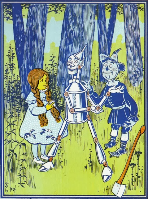 The Tin Woodman, able to put down his axe and move again after being oiled by Dorothy and the Scarecrow.