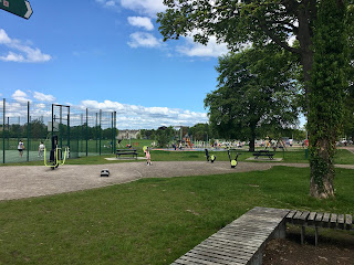 Tennis courts, a playpark, and outdoor exercise equipment in the park.