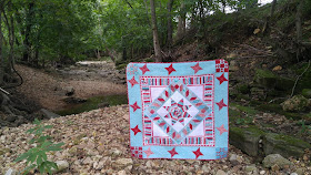 Red and aqua string star round robin quilt