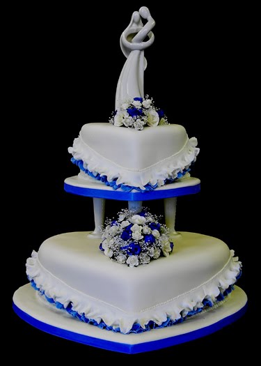 White heart shaped wedding cake with blue trimming