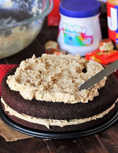 Spreading Peanut Butter Frosting on 2nd Layer of Cake Image