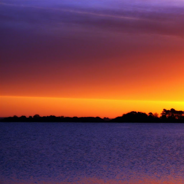 pink and purple sunrise on Oughterard pier, Galway, Ireland