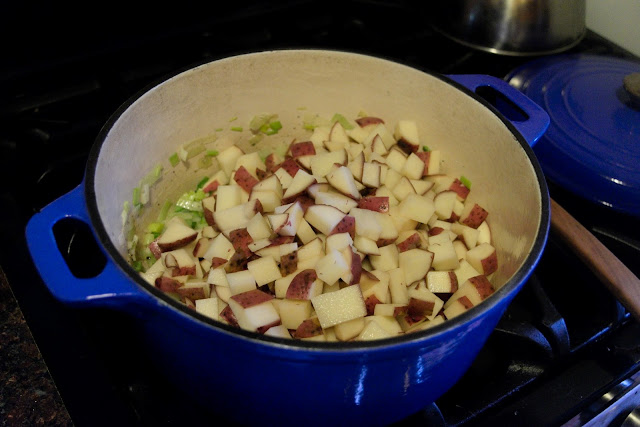 Potatoes being added tot he dutch oven.