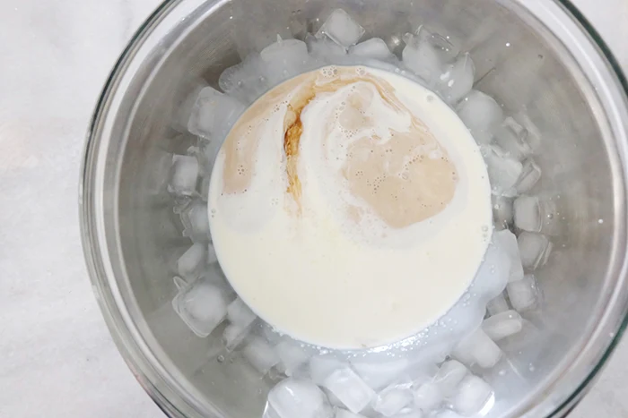 cream and vanilla in bowl in ice bath