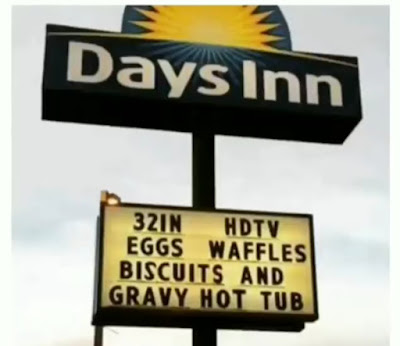 Hotel billboard advertising hotel amenities including: Eggs Waffles Biscuits and Gravy Hot Tub