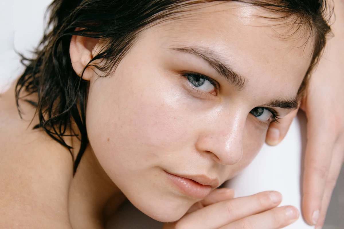 close-up portrait of a beautiful woman without makeup and with her skin glowing