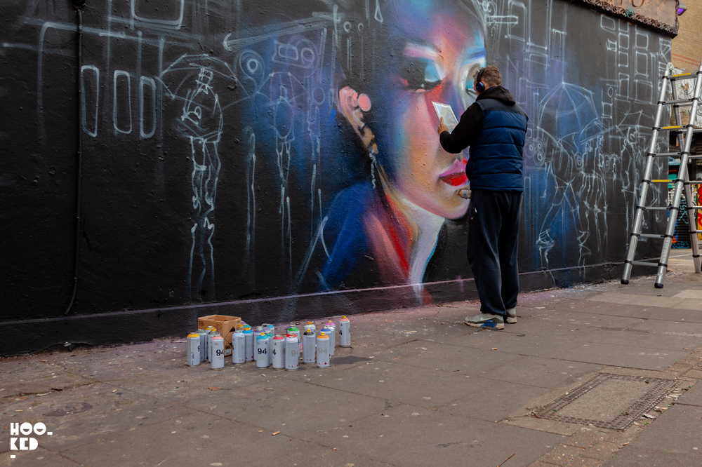 Shoreditch Street Art, London Street Artist Dan Kitchener aka DANK at work on a mural