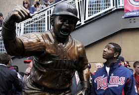 Kirby Puckett Jr stands by the statue of his father at Target Field
