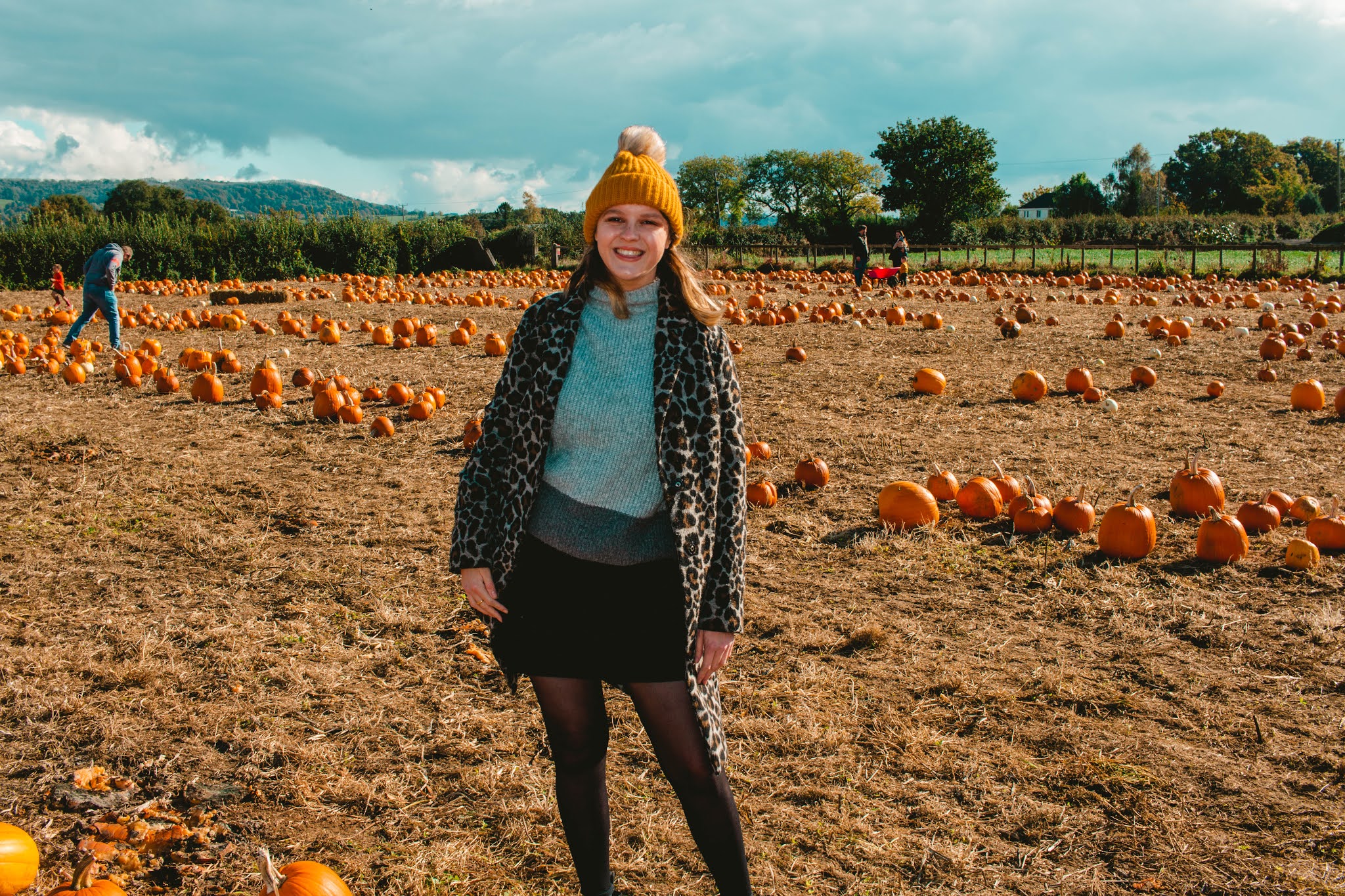 Girl with Autumn Pumpkins at Pumpkin Patch from Fall Pumpkin Picking Autumn Activities Blog Post