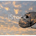 Satellite dish on sun rise cloudy sky background - Stock Image