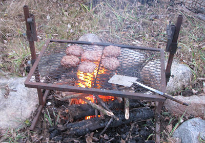 hamburgers on a grill over an open fire