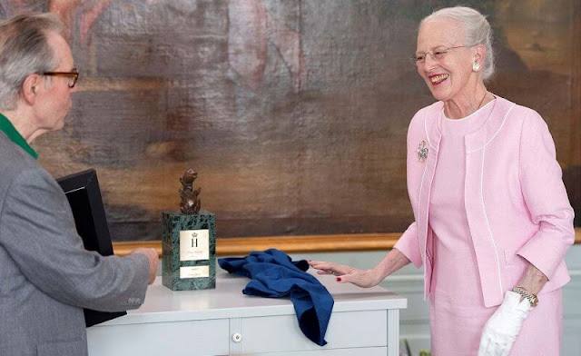 Queen Margrethe wore a pale pink outfit, jacket and dress. The award ceremony took place on the date of Prince Henrik's birthday