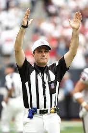 Referee on field with arms outstretched signalling touchdown.