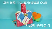 하트 모양이 보이도록 접는 종이접기 가방의 모양입니다.