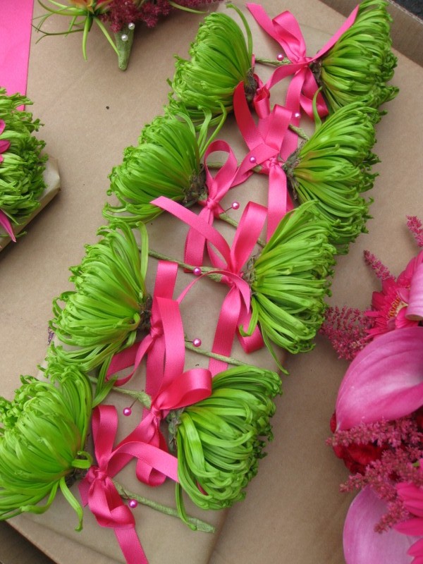 Bright green chrysanthymum made beautiful buttonholes Hot pink ribbon and 