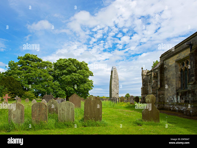 standing-stone-in-the-churchyard-of-all-saints-church-in-the-village-EW58AT.jpg