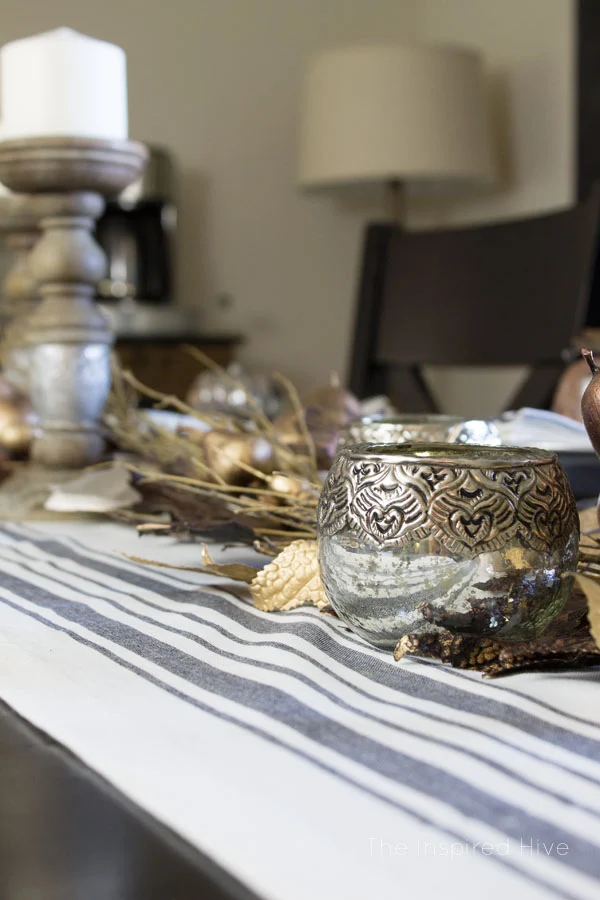 Beautiful farmhouse glam tablescape idea for fall decor and entertaining. I love the grainsack runner and the mercury glass candleholders!