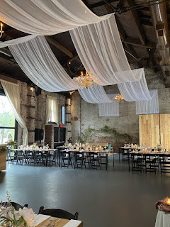 White sheer drapes suspended over the main room at The Green Building