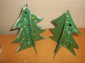 two finished standing paper christmas trees