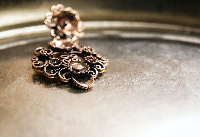 A pendant resting on a silver plate.