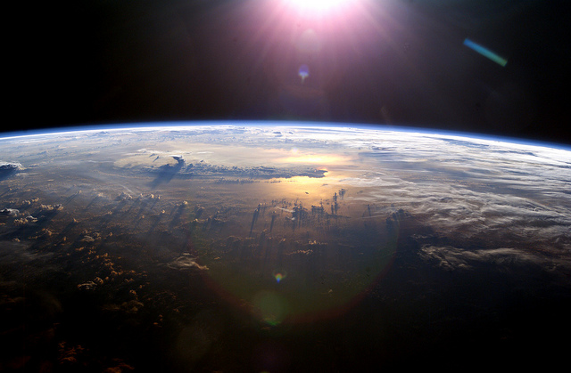 Fotografía espacial del sol sobre la tierra.