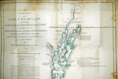 A photograph of an unfolded map titled "A Survey of Lake Champlain."
