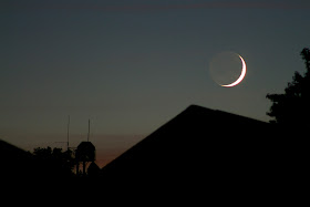crescent moonset over roof
