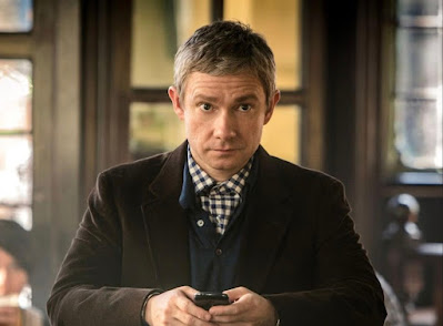 Martin Freeman as Dr Watson as he looks up from using his mobile phone