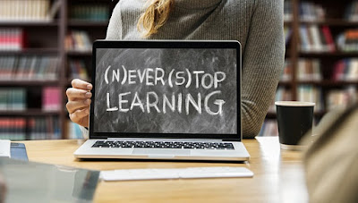 Laptop screen shows "(N)ever (S)top Learning"