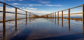 Photo of blue sky reflected in the ice on Maryport Pier