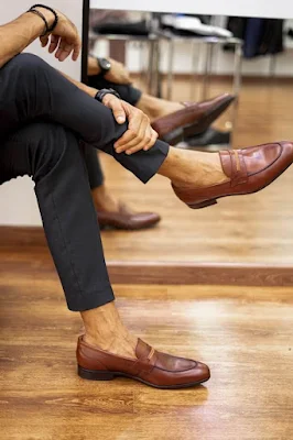 A Handsome Man Sitting and Wearing Brown Leather Shoes